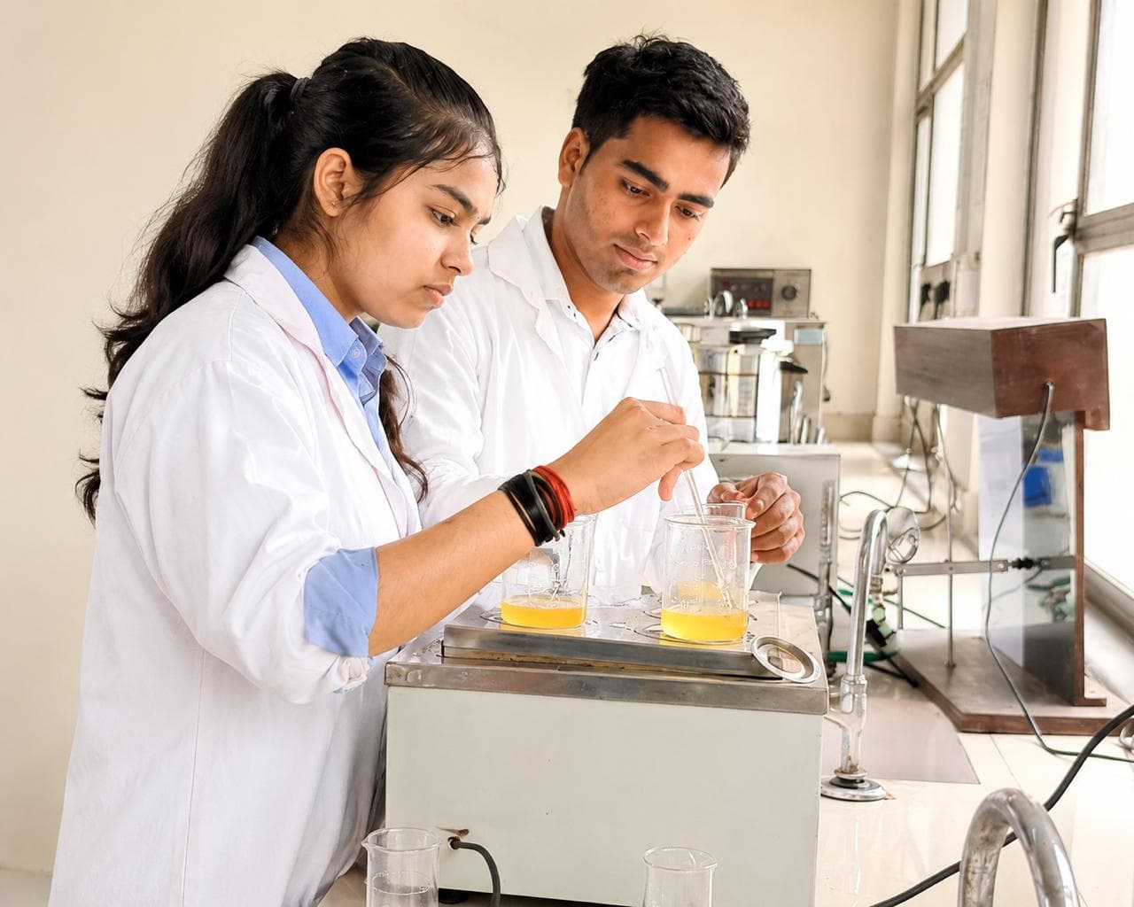Best B Pharm students performing laboratory practical experiments at top Ishan Pharmacy